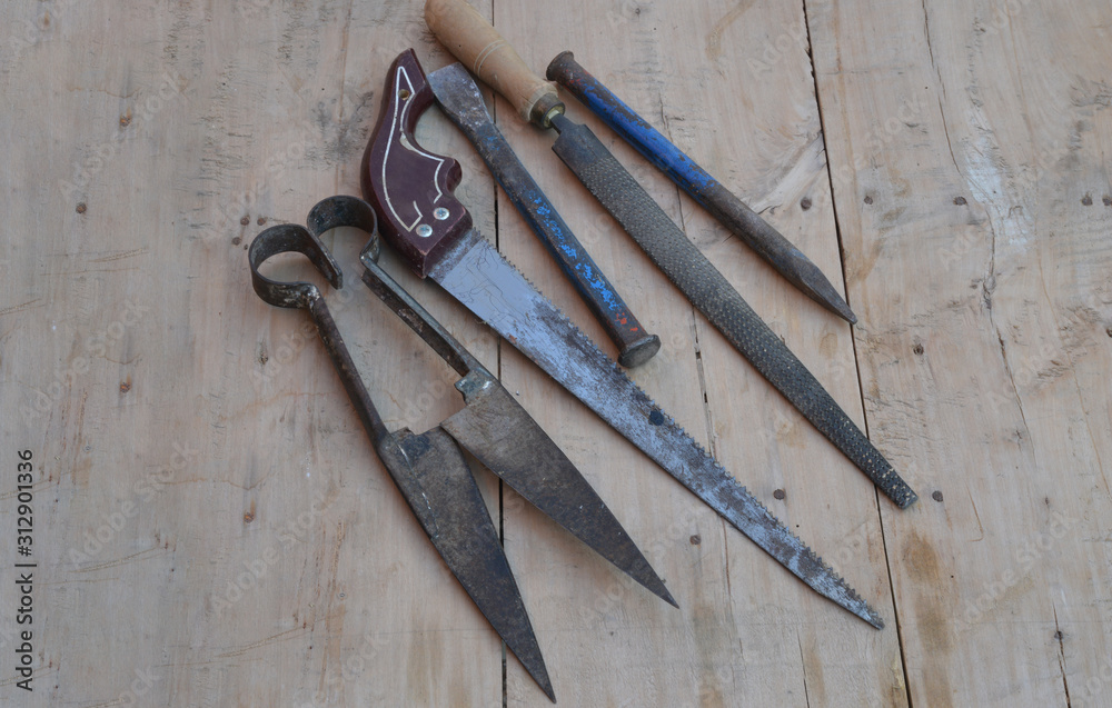 old construction of a house and repair tools on wooden background old construction of a house and repair tools on wooden background