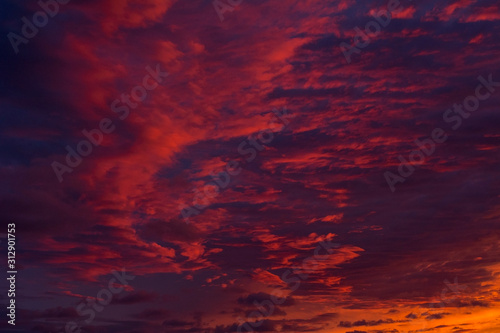 Beautiful red and blue evening sky with many clouds over the sea. Dramatic sky.