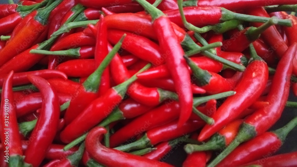 red and green peppers Fresh chillies, bright red flowers, large seeds