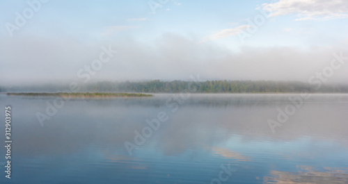 Fog on the lake. Pskov region, Russia