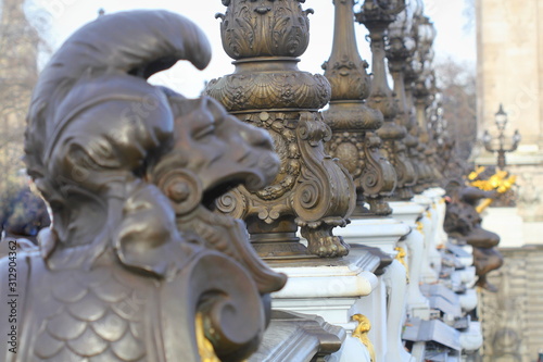 Architectural fragments of exuberant Art Nouveau lamps at famous Paris Alexandre III Bridge (Pont Alexandre III, 1900). Paris, France.