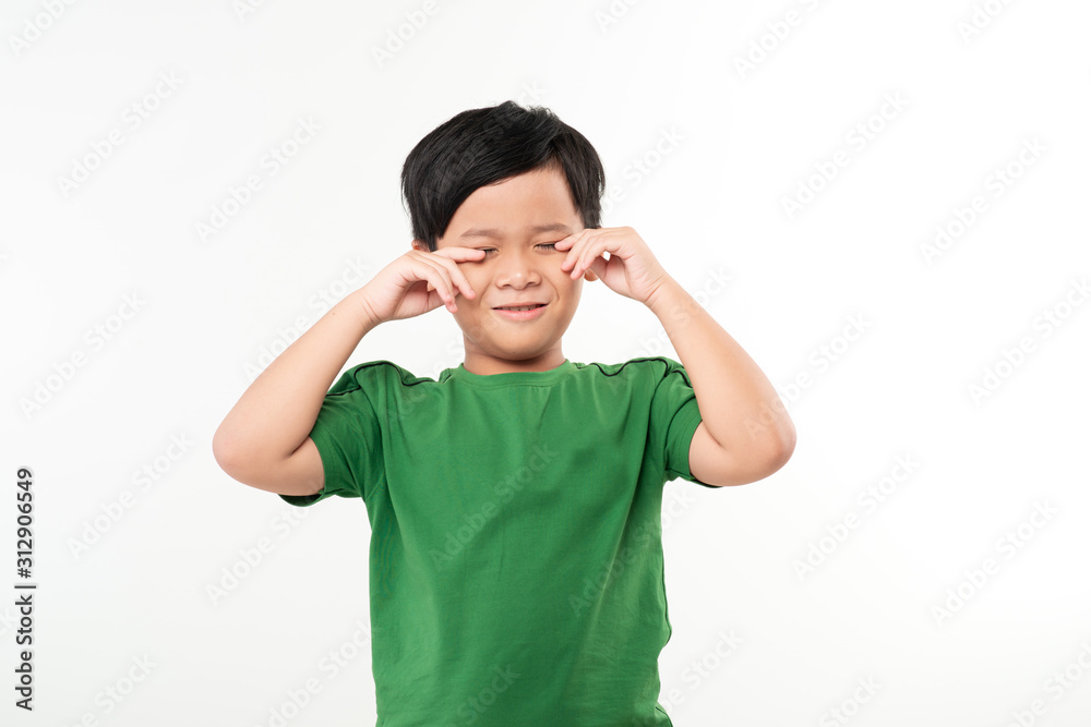 Little boy rubbing tired from active reading eyes Little boy rubbing tired from active reading eyes