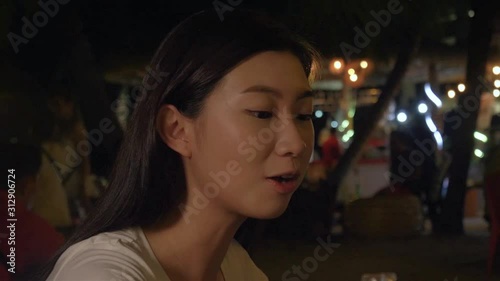 Beautiful Women Eating at the Night Market  photo