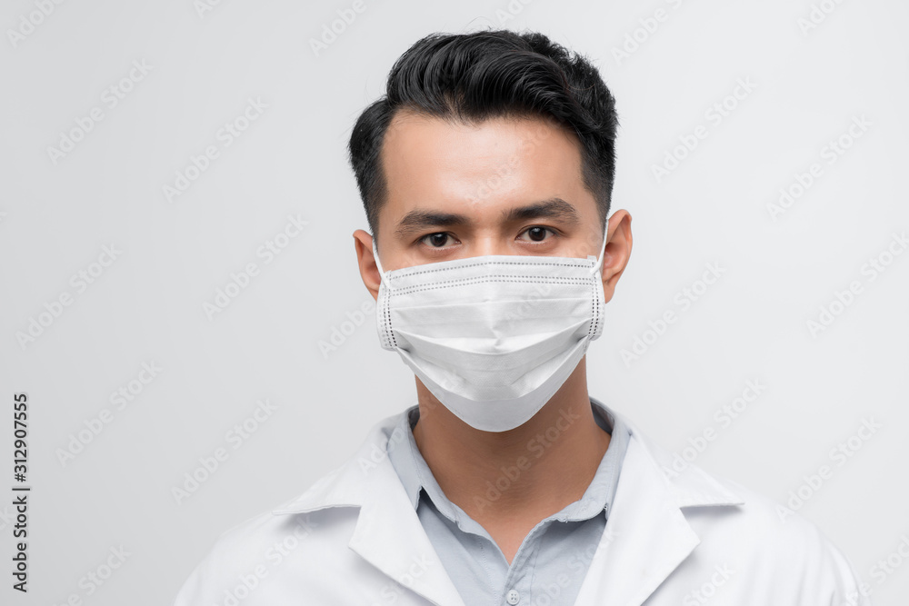 Handsome doctor portrait with a white coat, face mask Handsome doctor portrait with a white coat, face mask