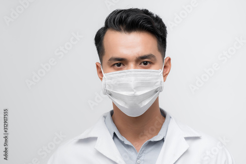 Handsome doctor portrait with a white coat, face mask