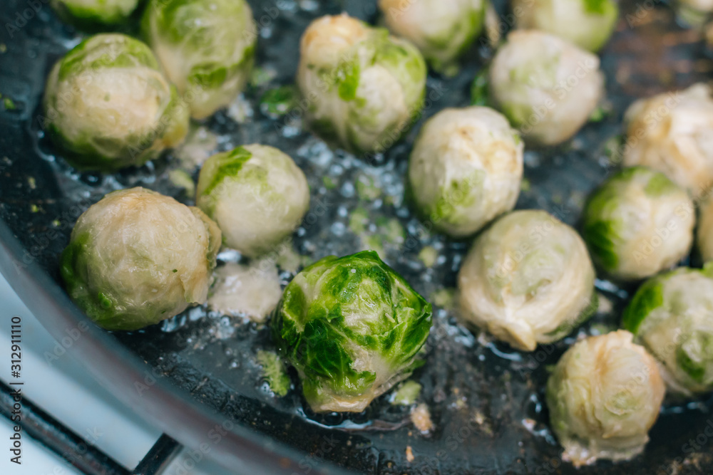 Brussels sprouts in the pan. Fried cabbage in butter Brussels sprouts in the pan. Fried cabbage in butter