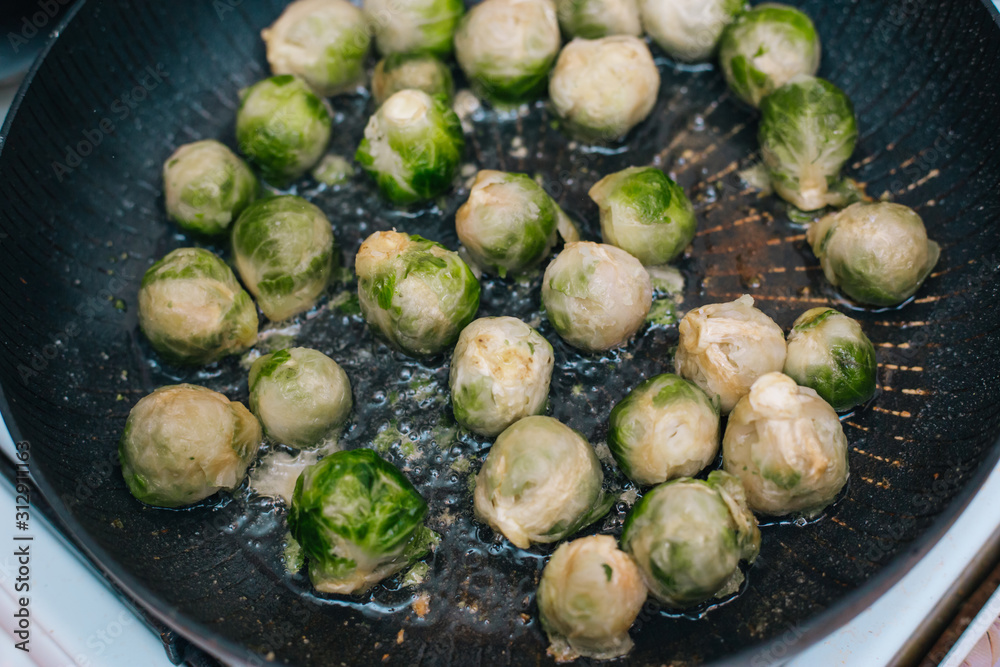 Brussels sprouts in the pan. Fried cabbage in butter Brussels sprouts in the pan. Fried cabbage in butter