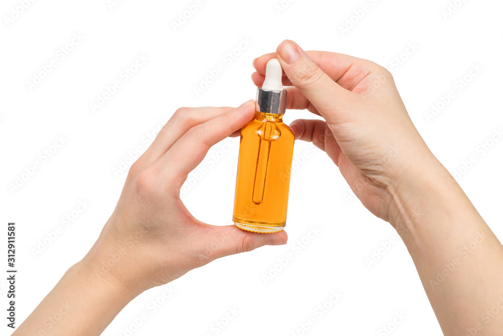 Bottle with oil in woman hand isolated on white. Bottle with oil in woman hand isolated on white.