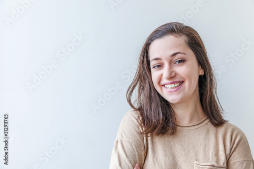 Happy girl smiling. Beauty portrait young happy positive laughing brunette woman on white background isolated. European woman. Positive human emotion facial expression body language photo