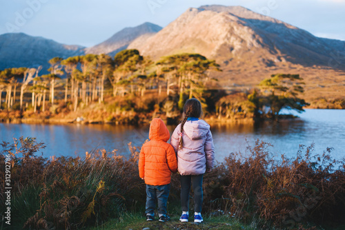 boy and girl looking at mountain photo