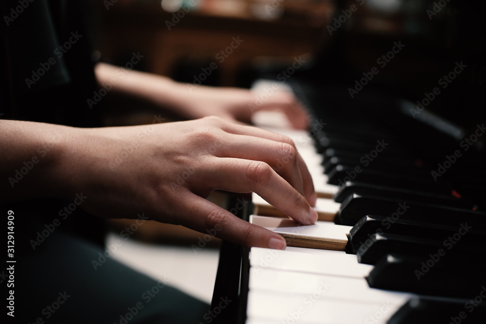 Beautiful asian girl learn to play piano.