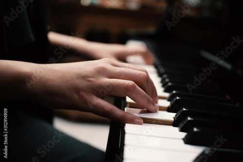 Beautiful asian girl learn to play piano.