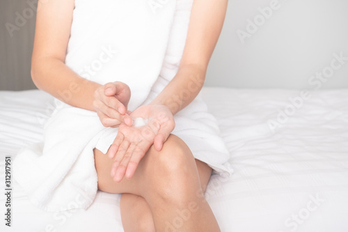 Woman applying moisturizing cream/lotion on hands, beauty concept.. © BoszyArtis