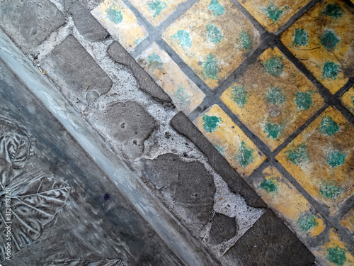 Plant pattern in cement floor and tegel koentji or kunci (javanese traditional tile) as floor material