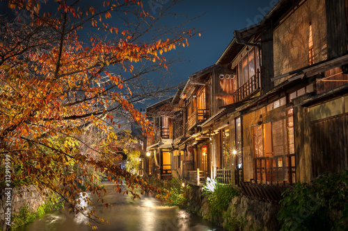 A stream runs past old wooden houses on Shirakawa Dori in the Gion district of Kyoto, Japan photo