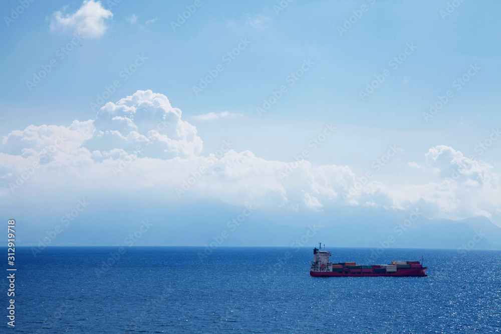 Cargo ship with containers in deep blue sea