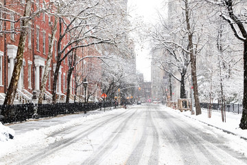 Snowy streets and sidewalks along Washington Square Park during a winter blizzard in New York City