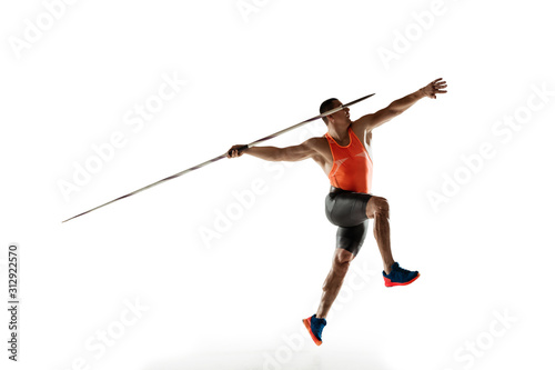 Male athlete practicing in throwing javelin isolated on white studio background. Professional sportsman training in motion, action. Concept of healthy lifestyle, movement, activity. Copyspace. photo