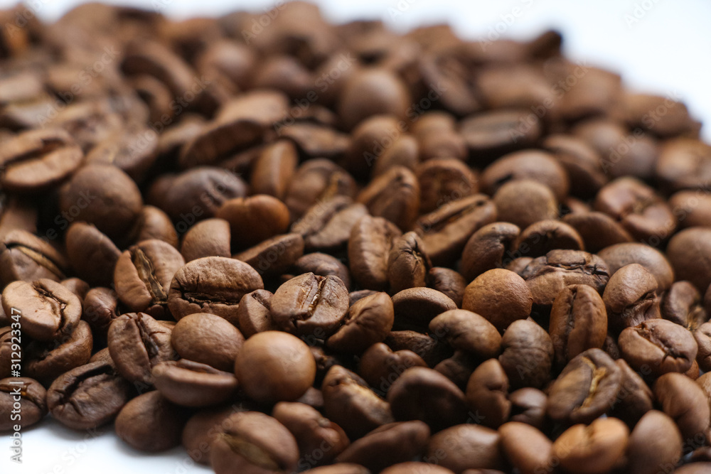Close up view of brown roasted coffee beans. Blend of 70% arabica and 30% robusta is used for this photo. Theme of drinks ingredients. Coffee background. Selective focus. Close up view of brown roasted coffee beans. Blend of 70% arabica and 30% robusta is used for this photo. Theme of drinks ingredients. Coffee background. Selective focus.