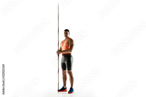 Male athlete practicing in throwing javelin isolated on white background. Professional sportsman, thrower posing confident. Concept of healthy lifestyle, movement, activity, competition. Copyspace.