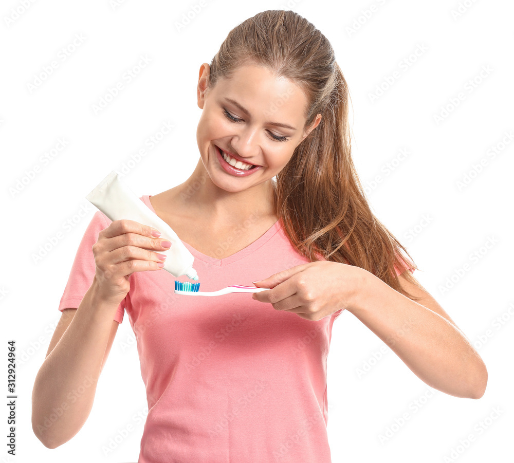 Young woman with toothbrush and paste on white background