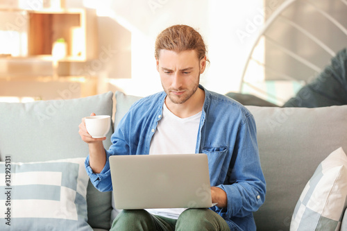 Handsome man with laptop dr...