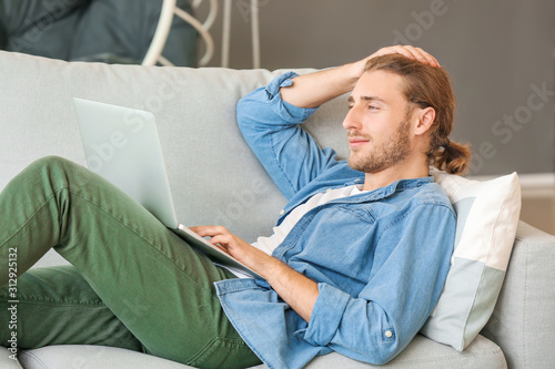 Handsome man with laptop on...