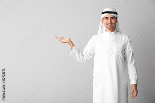 Handsome Arab man on light background