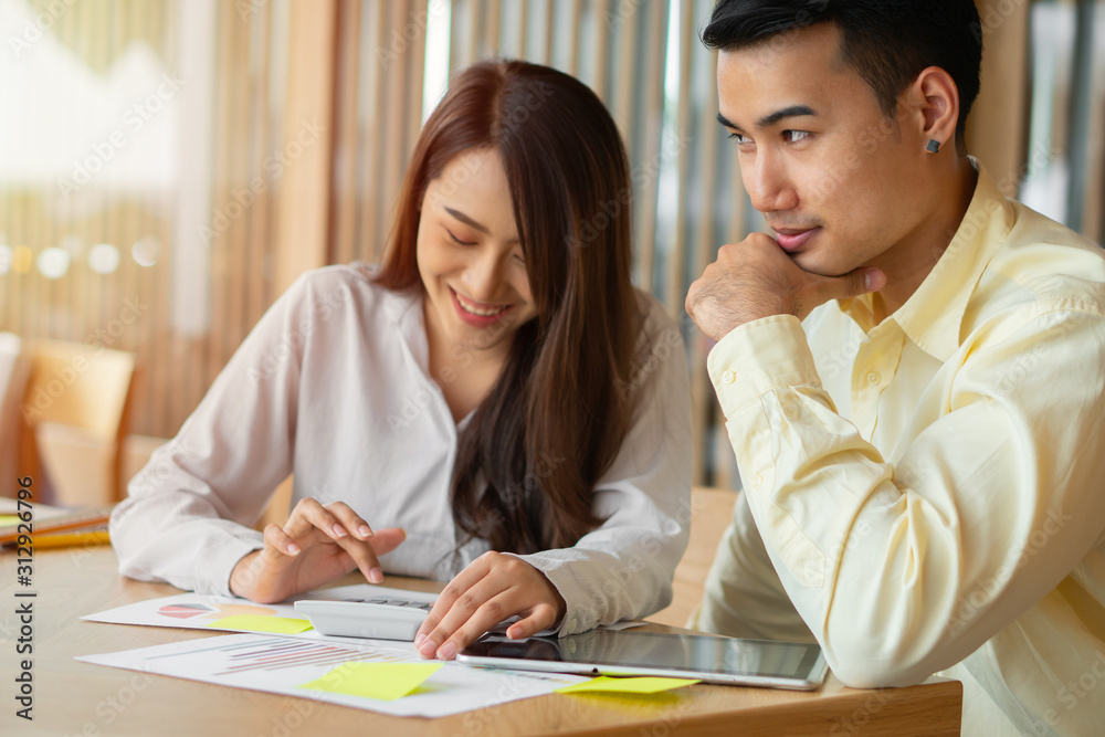 Asian couples are calculating income And expenses To cut unnecessary expenses And planning to borrow money to buy a new home. Concepts for investment planning and financial planning for the family Asian couples are calculating income And expenses To cut unnecessary expenses And planning to borrow money to buy a new home. Concepts for investment planning and financial planning for the family