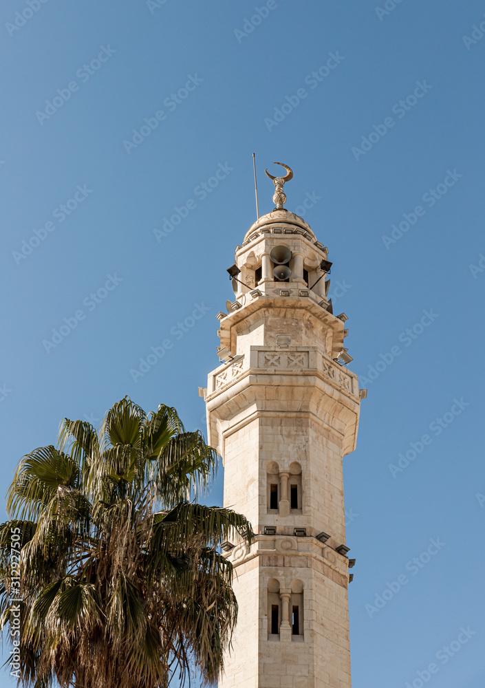 A mosque with a minaret stands in the main square  - Manger Square - in Bethlehem in Palestine