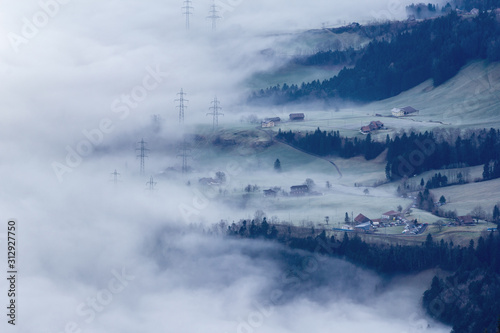 Alps village in sea of clouds and high fog in winter season