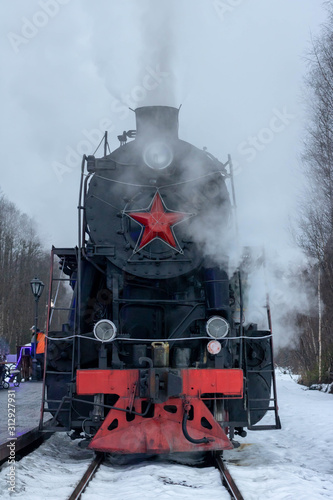 This is a photo of the front of an old steam retro locomotive