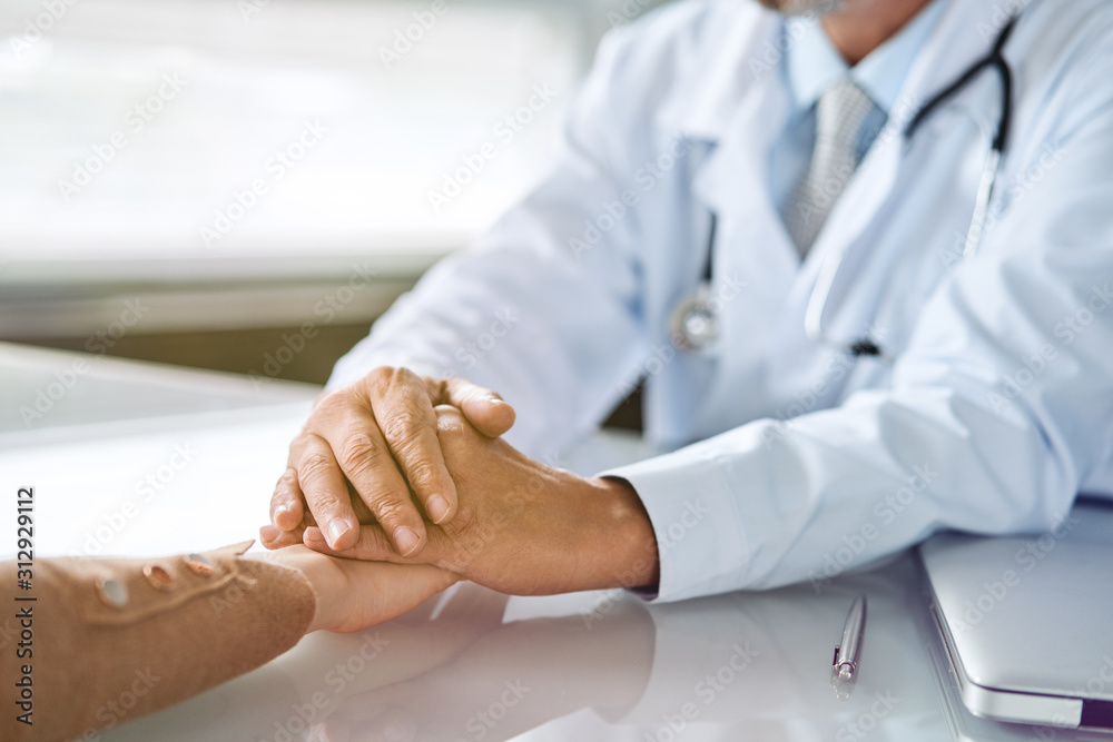 Doctor and patient are discussing something, just hands at the table Doctor and patient are discussing something, just hands at the table