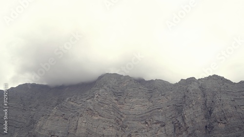 Mountain landscape moving clouds in Ras al Khaimah uae , fog and mist on layer mountain range low angle view Landscape, uae nature ,ras al Khaimah Mountains