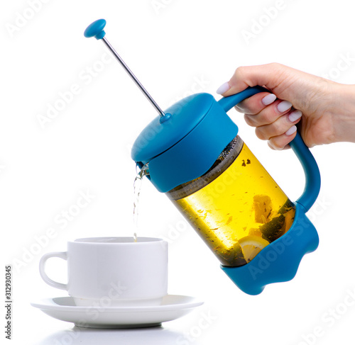 French Press teapot with saucer and cup on white background isolation