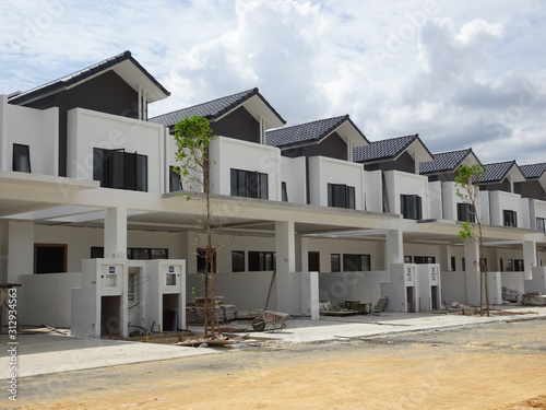 Double story luxury terrace house under construction in Malaysia.  Designed by an architect with a modern and contemporary style.  © Aisyaqilumar