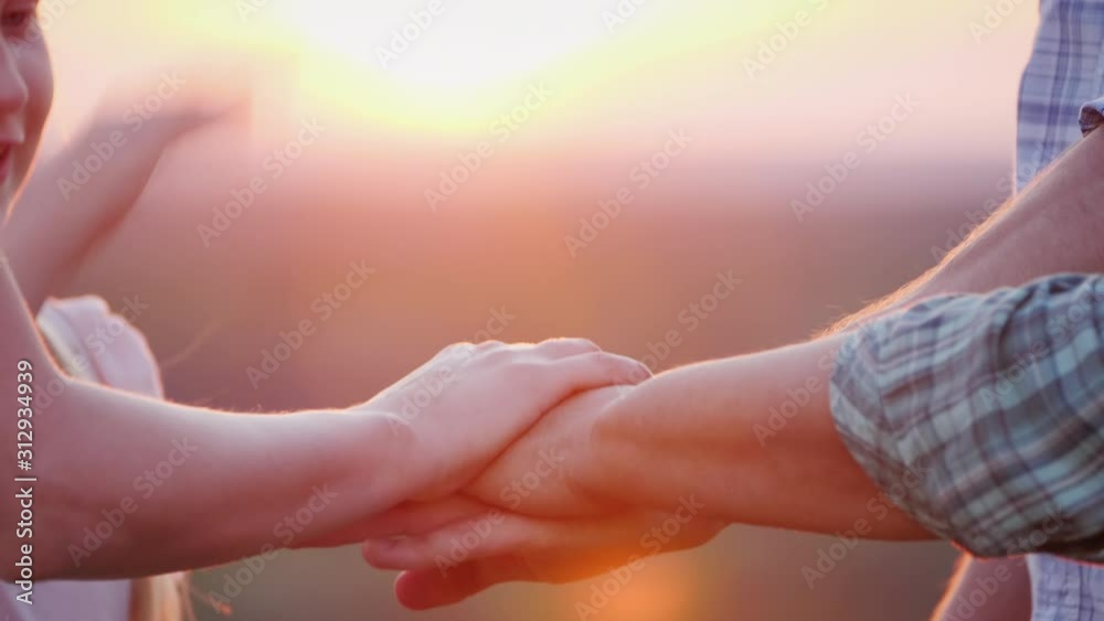 A team of volunteers puts their hands on top of each other before starting work. Motivation and teamwork concept A team of volunteers puts their hands on top of each other before starting work. Motivation and teamwork concept