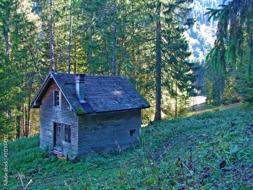 Traditional architecture and farmhouses on the Churfirsten mountain range and in the Toggenburg region, Starkenbach - Canton of St. Gallen, Switzerland photo