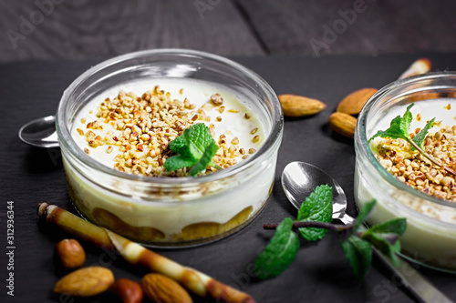 Cheesecake creamy in glass bowl on rustic table, cheesecake creamy with nuts