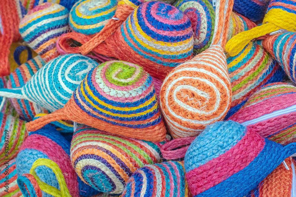 Close up to vintage handicraft colorful bags by yarn for sale at local market in Thailand. Selective focus.
