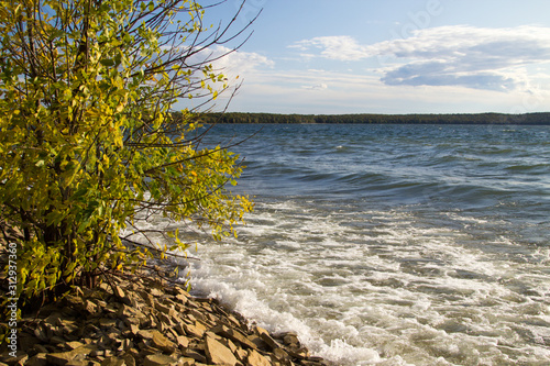 Shores Of Lake Superior. Waves crash on a rocky Lake Superior beach on a warm fall day in the Upper Peninsula of Michigan.
