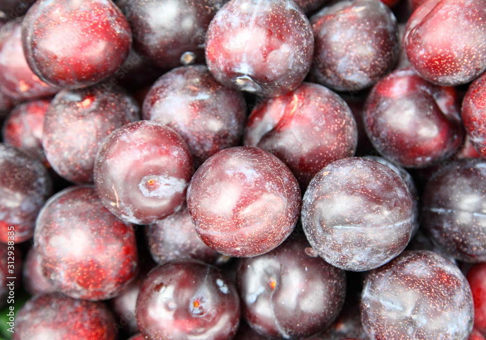 Lots of delicious looking very fresh peaches on sale at an outside market on a sunny Saturday.