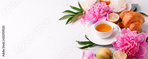 Peonies and cup of tea on white background. Spring flowers. Spring breakfast ...