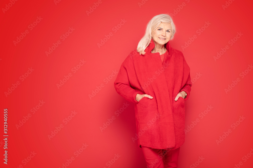 Fototapeta premium Senior lady in red fashionable clotes.
