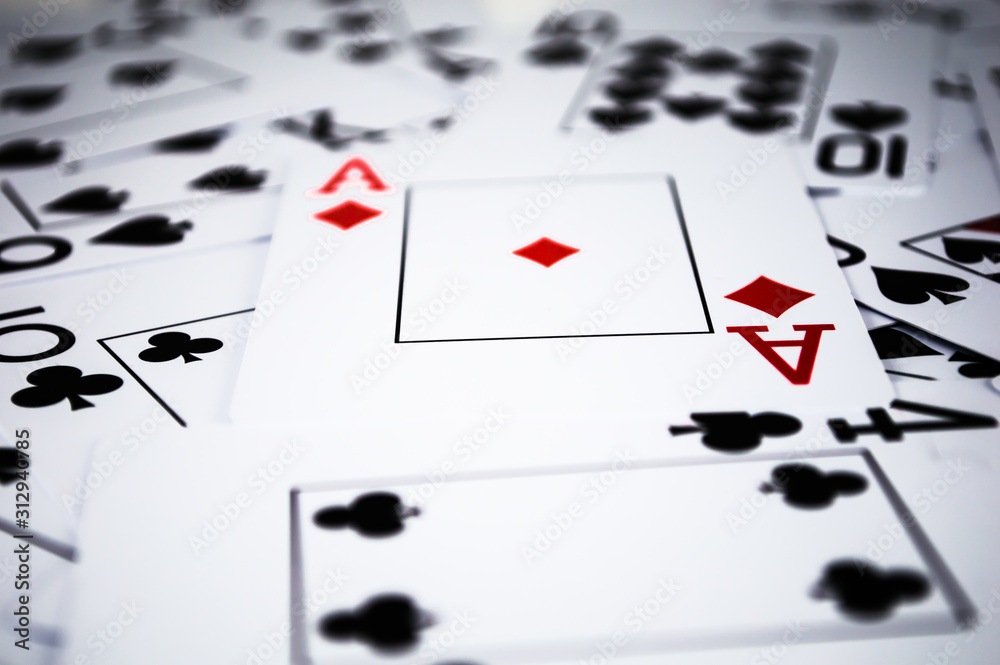 Black playing cards with one red card in chaos Black playing cards with one red card in chaos