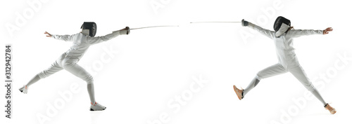 Tableau sur toile Teen girls in fencing costumes with swords in hands isolated on white studio background