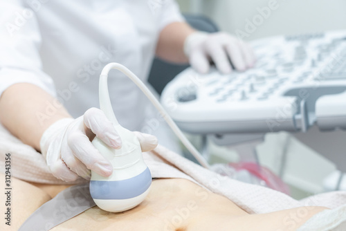 Gynecologist doing ultrasound scan in modern clinic photo