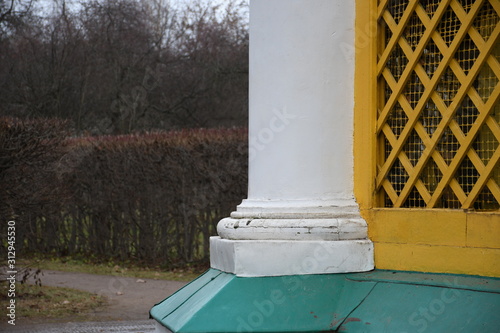 columns of the building. yellow wood grill. 