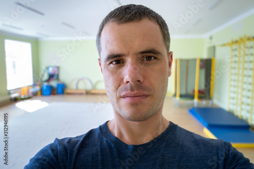 Portrait of a young serious man inside a sports gym.