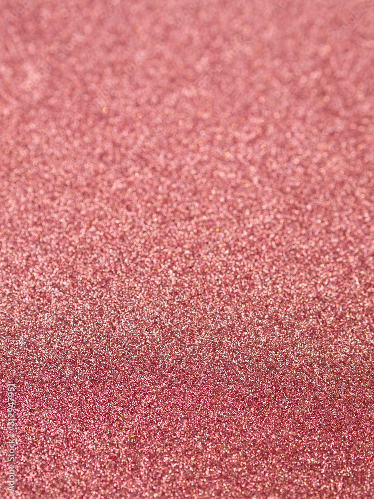 Fototapeta premium Vertical red brilliant shiny texture glitter with selective focus for holiday background card
